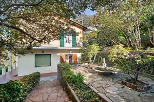 a house with a garden and a stone patio at Uliveto in Camogli