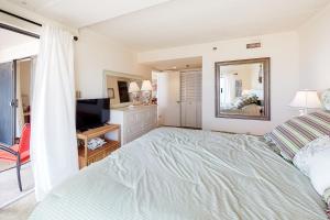 a bedroom with a bed and a flat screen tv at Waikiki #302 in Ocean City +12 photos