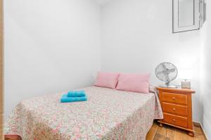 a bedroom with a bed with a blue object on it at Casa Ramón Antonio in Las Palmas de Gran Canaria