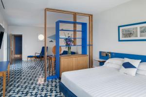a bedroom with a bed and a blue ladder at Parco dei Principi in Sorrento +165 photos