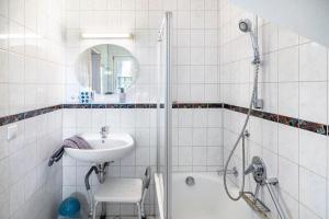 a white bathroom with a sink and a shower at Ferienwohnungen Meyer in Hochbuch +51 photos