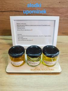 two jars of food sitting on a tray at Kolory Warmii Apartament Niebieski in Olsztyn