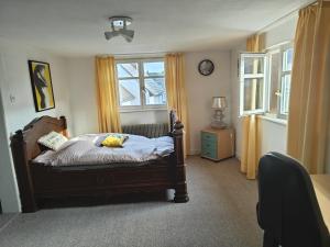 a bedroom with a bed with a stuffed animal on it at Appartement Aux Deux Cigognes Bis in Gries