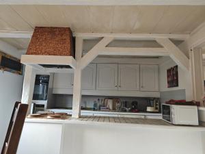 a kitchen with white cabinets and a counter top at Appartement Aux Deux Cigognes Bis in Gries