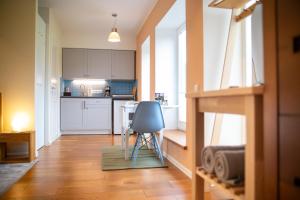 a kitchen with a chair in the middle of a room at Charming Lahemaa national park Studio apartment for Nature Lovers in Kolga +14 photos