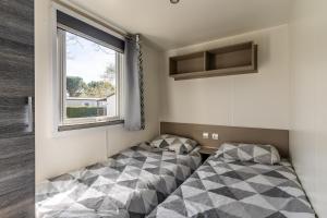 En eller flere senge i et værelse på Séjour nature et confort