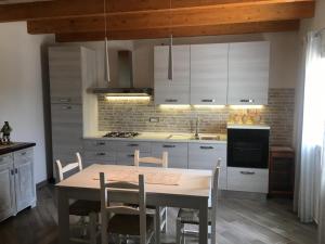 Domu Quesada في سان جيوفاني سويرجيو: مطبخ مع طاولة وكراسي في الغرفة