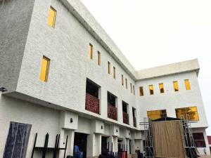a building with yellow windows on the side of it at Victoria Garden Hotel & Fast Food Service in Onitsha