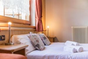 ein Schlafzimmer mit einem Bett mit Handtüchern darauf in der Unterkunft Sole - Casa Azzurra Piano Terra in Livigno