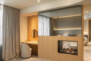 a living room with a fireplace and a mirror at Carlemany Girona in Girona +124 photos