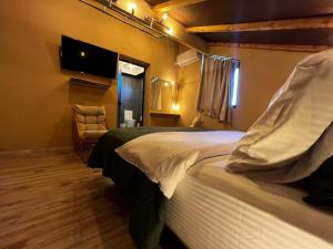 a hotel room with a bed and a tv at Sacred Stay in Shkodër