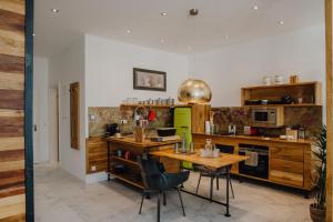 a kitchen with a table and chairs in a room at Sky Suites & Sky Bar in Weimar