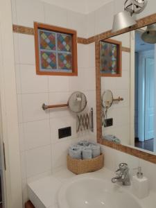 a bathroom with a sink and a mirror at Isola Blu Milano in Milan +20 photos