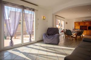 a living room with a large window and a table at Villa La Londe les Maures in La Londe-les-Maures