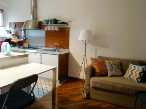 a living room with a couch and a kitchen at Isola Blu Milano in Milan