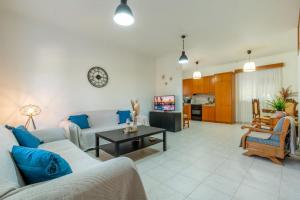 a living room with a couch and a table at Mike's House in Kremasti near the Beach Rhodes in Kremasti