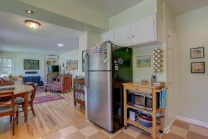 a kitchen with a stainless steel refrigerator and a table at Living Color Cottage in Hood River