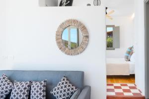 a living room with a couch and a mirror at Luna Rossa Milos - Chili Moon in Provatas +21 photos