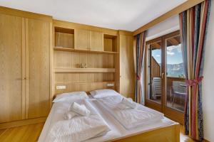 ein Schlafzimmer mit zwei weißen Handtüchern auf einem Bett in der Unterkunft Ferienwohnung Meran in Mölten