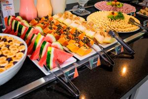 a buffet with many different types of fruit and snacks at Hotel Sagres Praia in Balneário Camboriú