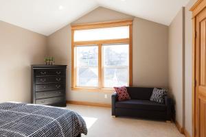 a bedroom with a bed and a chair and a window at Private Reserve 30 day minimum in Hood River