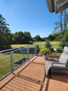 a patio with a fence and a couch and a chair at Beim Mooswiesler Dahoam in Polling