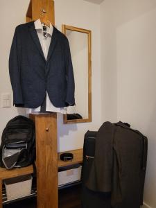 a suit hanging on a pole next to a mirror at Beim Mooswiesler Dahoam in Polling