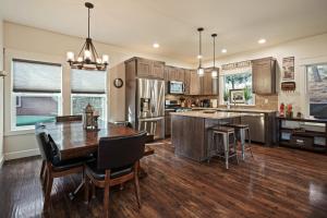 a kitchen with a wooden table and a dining room at Trails End Retreat in Bend
