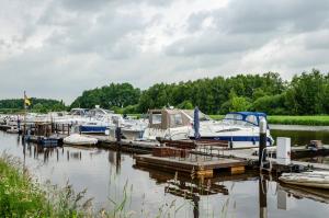a bunch of boats are docked at a marina at Fewo2 Seelter Uutkiek Saterland in Bollingen