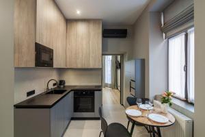 a kitchen with a table and chairs and a dining room at Royal jacuzzi apartment on Krehivska 10 st in Lviv +6 photos