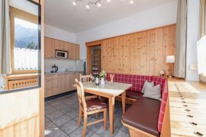 a kitchen and dining room with a table and chairs at Haus Scheiblauer in Tröpolach