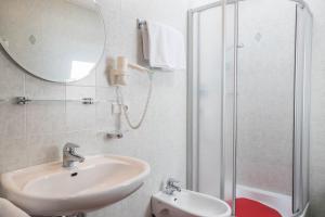 a bathroom with a sink and a shower at Apartment Kornblume - Mesnerhof in Sand in Taufers +11 photos