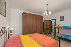 a bedroom with a bed and a bunk bed at Il Pino - appartamento Alloro in Cecina +17 photos