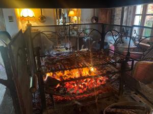 a kitchen with a fire oven with food in it at La Maison De Mon Père in Le Nayrac