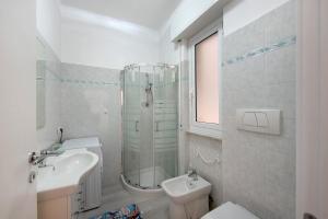 a bathroom with a sink and a toilet and a shower at Arenzano A Due passi dal mare in Arenzano +17 photos