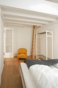 a bedroom with a bunk bed and a chair at Fewo Romeo und Julia in Bamberg