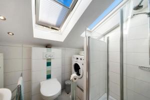 Un baño con inodoro, lavabo y ventana. en Ferienwohnung Panoramablick, en Lenzkirch 17 fotos más