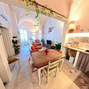 a living room with a table and a couch at Al Palazzotto in Fasano
