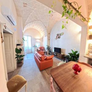 a living room with a table and a couch at Al Palazzotto in Fasano