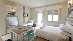 a bedroom with a bed and a table and chairs at City Loft in Piacenza