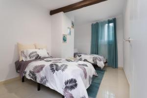 a bedroom with two beds and a window at Los Abuelos 3 Icod in Icod de los Vinos