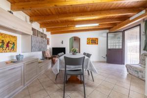a kitchen with a table and a dining room at Casa Silvia in Calasetta