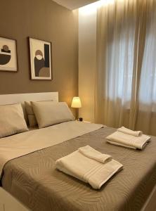 a bedroom with a bed with two towels on it at La Terrazza di Luca in Tavernelle