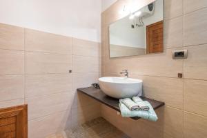 a bathroom with a sink and a mirror at Villa Fico in Domus de Maria