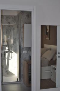 a bedroom with a bed and a glass door with a mirror at La Terrazza di Luca in Tavernelle +40 photos