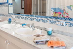 a bathroom with two sinks and towels on a counter at Ca S'hereu in Felanitx +17 photos