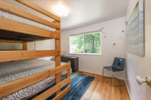 a bedroom with two bunk beds and a chair at Point Lyle in Mosier