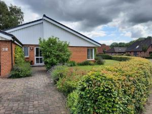 a brick house with a brick driveway at Ferienhaus Sprante in Brunsbüttel