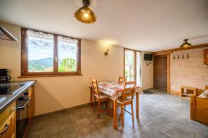 a kitchen and dining room with a table and chairs at Chalet La Sportive in Cornimont