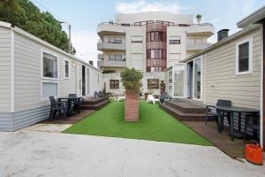 a patio with tables and chairs in front of a building at Villa Granja Sol 2 in São Félix da Marinha